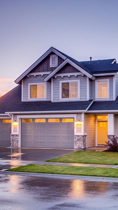House outdoor with lights on in sunset time